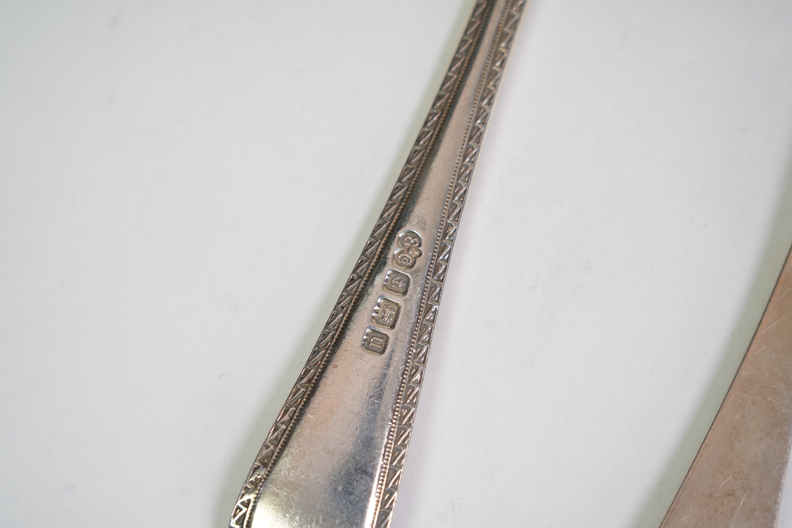 A set of six George V fancy Old English pattern table spoons by Elkington & Co, Birmingham, 1919, 22.2cm, together with a set of six fancy Hanoverian pattern table forks, Goldsmiths & Silversmiths Co Ltd, London, 1918, 3